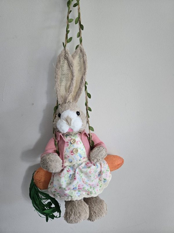 Female Easter Bunny sitting on a carrot